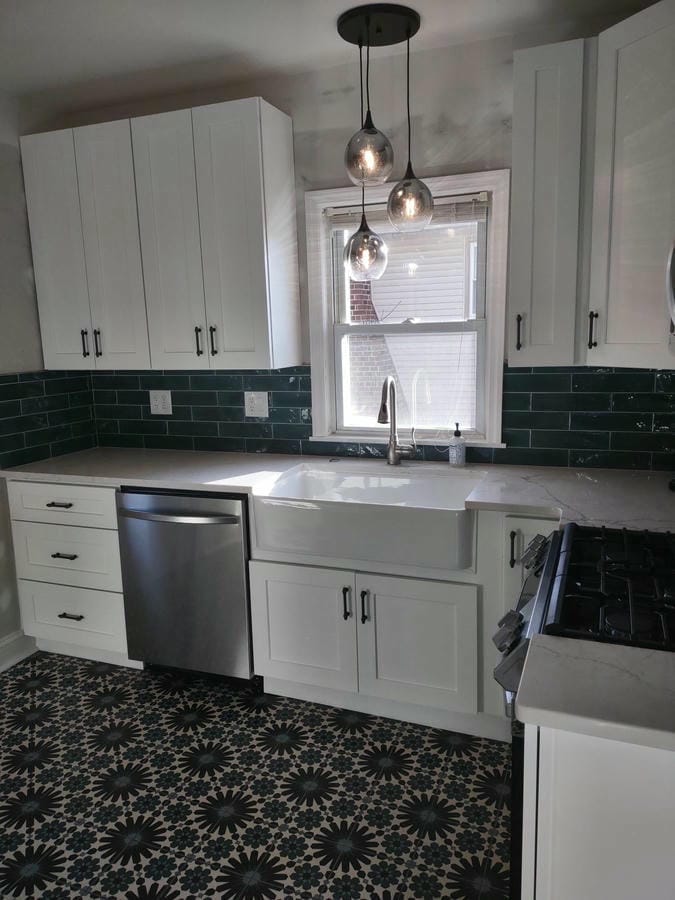 White kitchen remodel with an island and gray subway tile