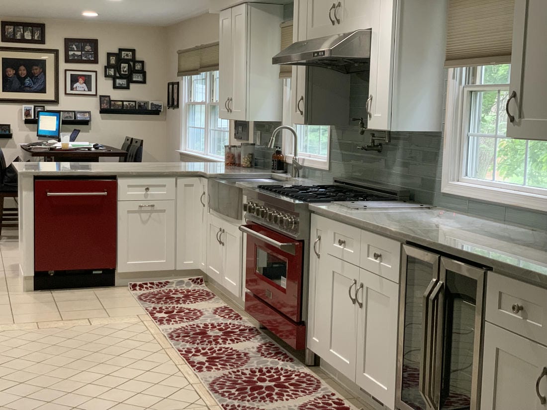 White kitchen remodel with an island and gray subway tile
