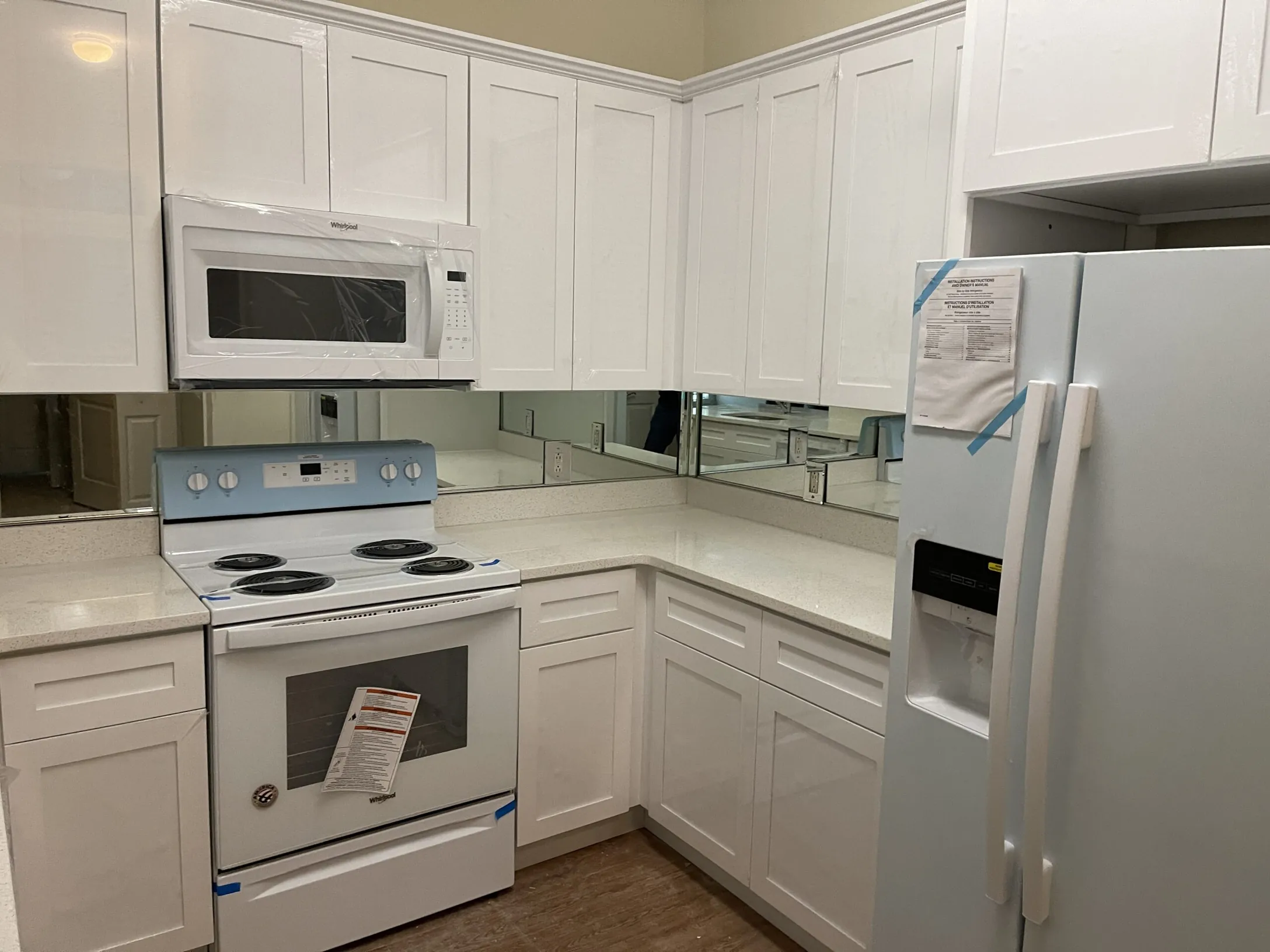 White kitchen remodel with an island and gray subway tile